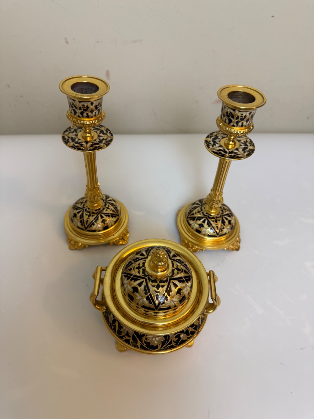 A nineteenth-century French writing set featuring a covered central inkwell flanked by two matching gilt bronze and champleve enamel candlesticks. View VII