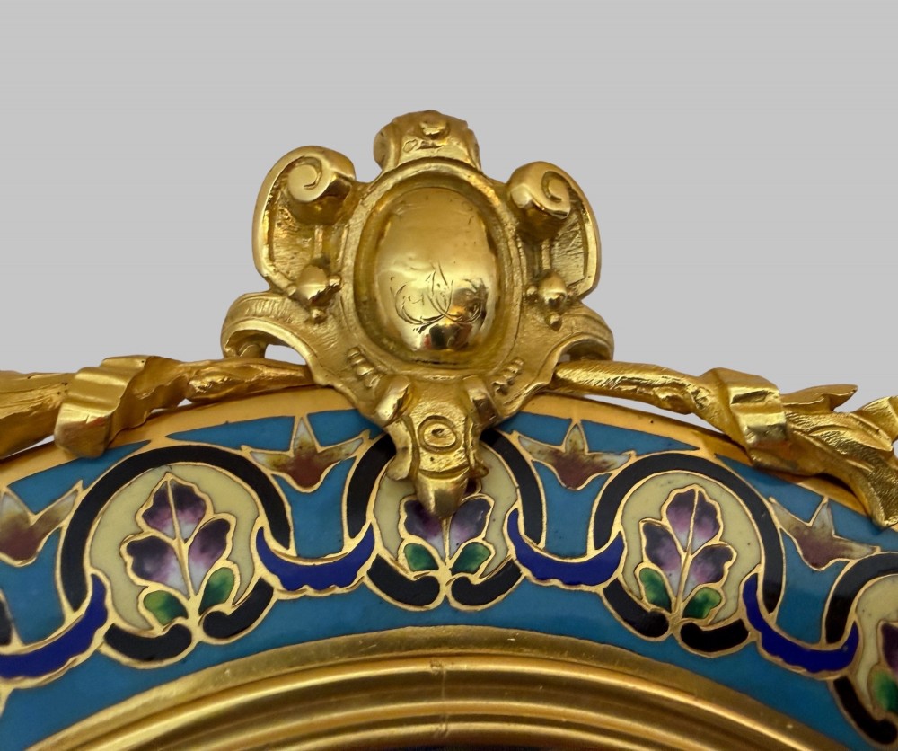 An oval late nineteenth-century French table mirror featuring a gilt bronze frame with blue champleve enamel scrollwork and ornate cast feet. View VI