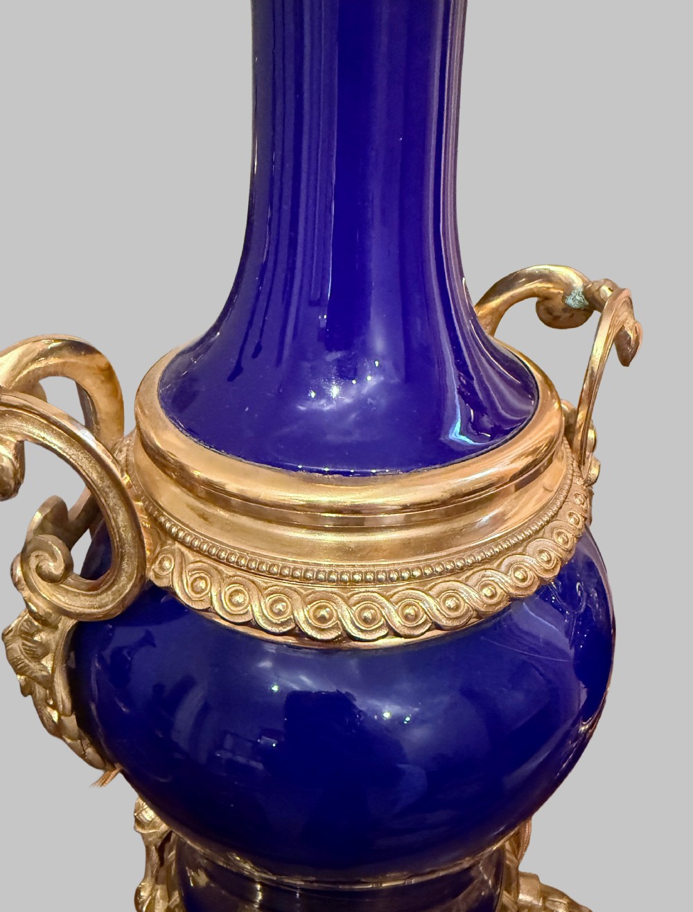 A pair of 19th-century French cobalt blue porcelain table lamps with gilt bronze ormolu mounts and scrolled handles. View II