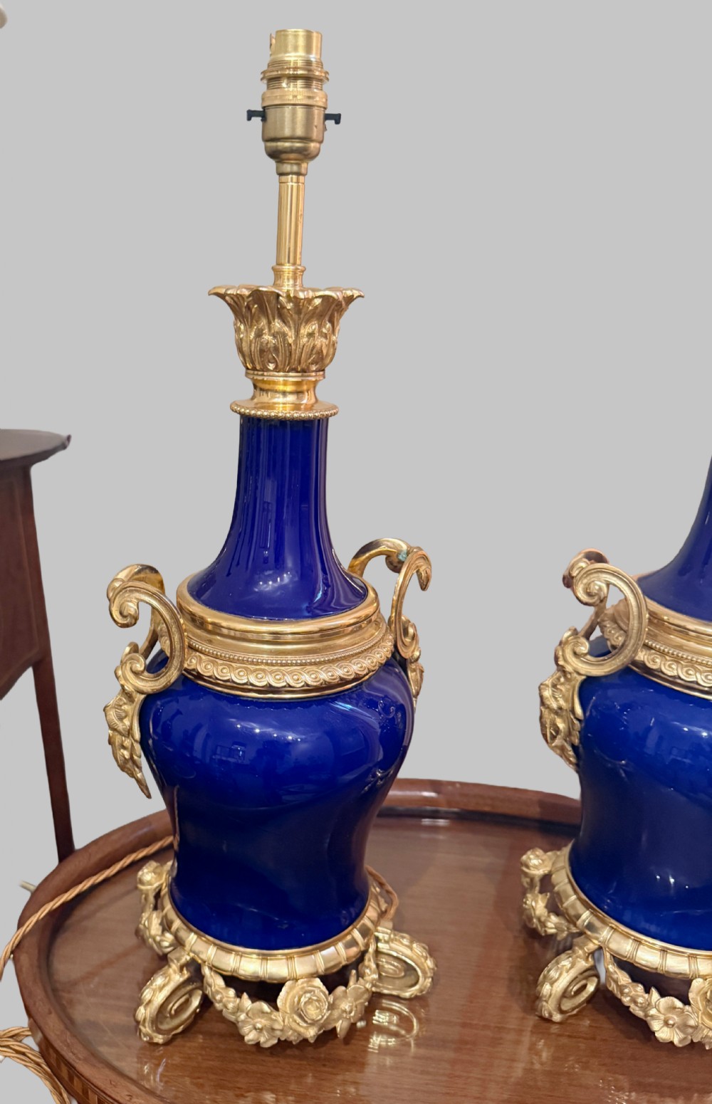 A pair of 19th-century French cobalt blue porcelain table lamps with gilt bronze ormolu mounts and scrolled handles. View III