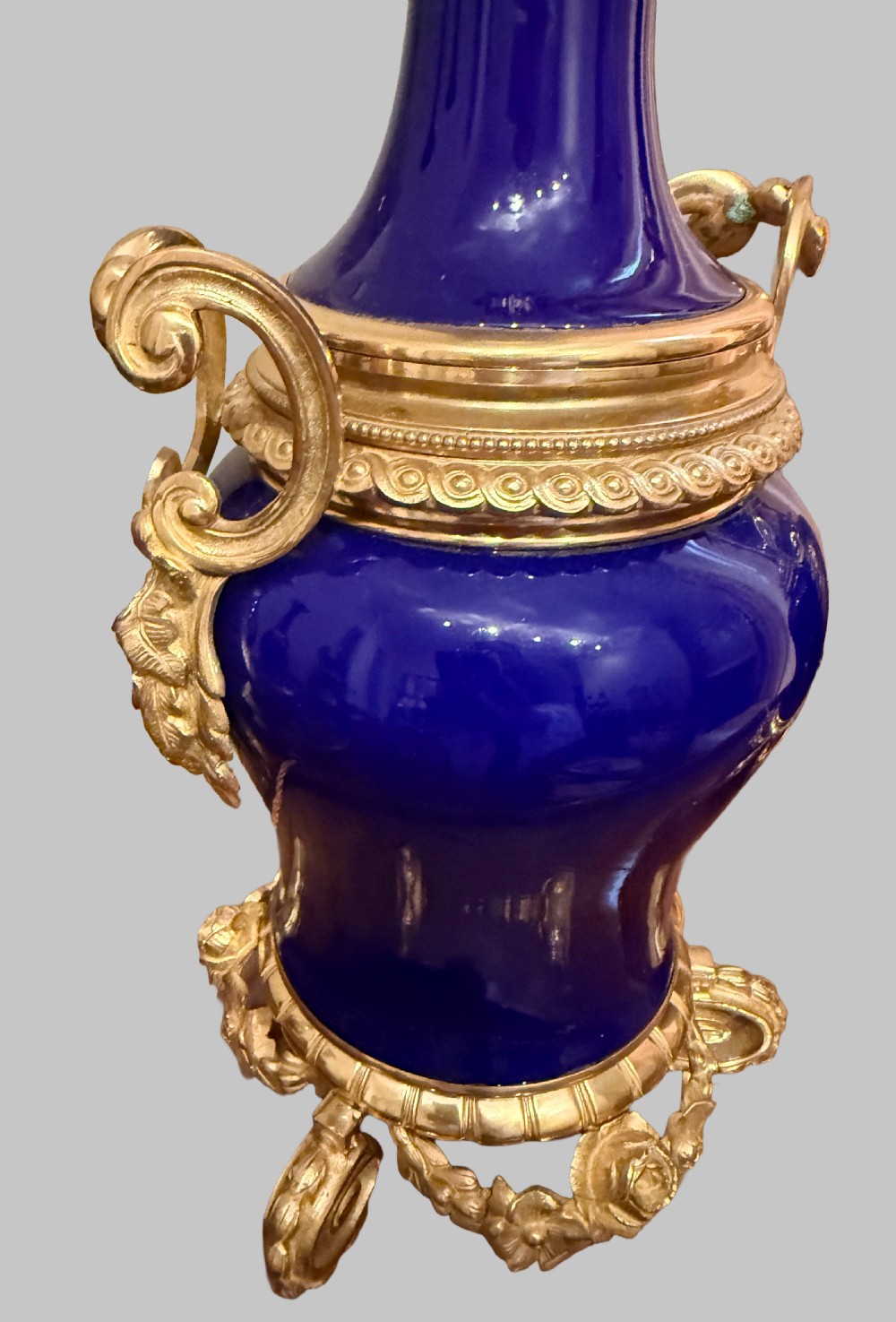 A pair of 19th-century French cobalt blue porcelain table lamps with gilt bronze ormolu mounts and scrolled handles. View IV