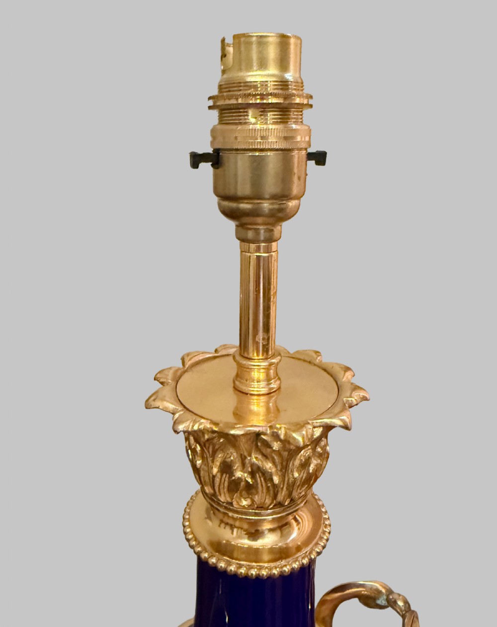 A pair of 19th-century French cobalt blue porcelain table lamps with gilt bronze ormolu mounts and scrolled handles. View V