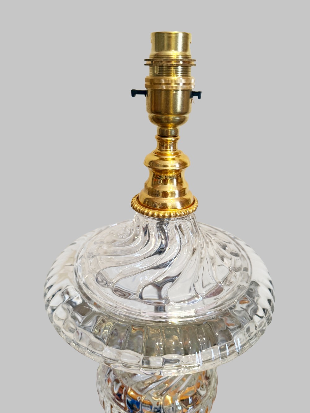 A pair of 19th-century French clear cut-crystal urn-form table lamps featuring spiral fluting, square pedestals, and gilt-metal claw feet. View III