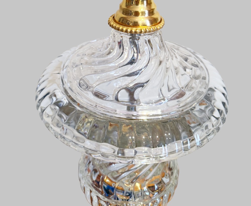 A pair of 19th-century French clear cut-crystal urn-form table lamps featuring spiral fluting, square pedestals, and gilt-metal claw feet. View IV