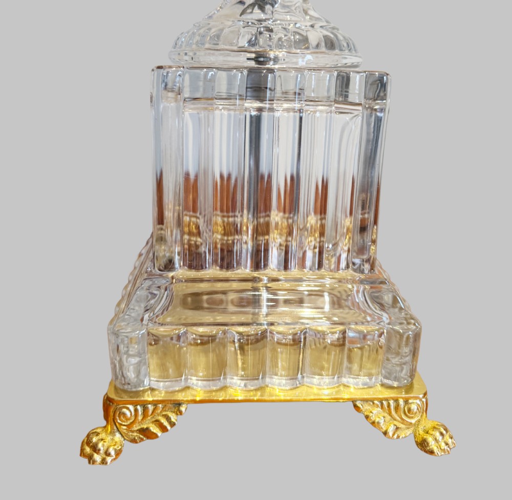 A pair of 19th-century French clear cut-crystal urn-form table lamps featuring spiral fluting, square pedestals, and gilt-metal claw feet. View VI