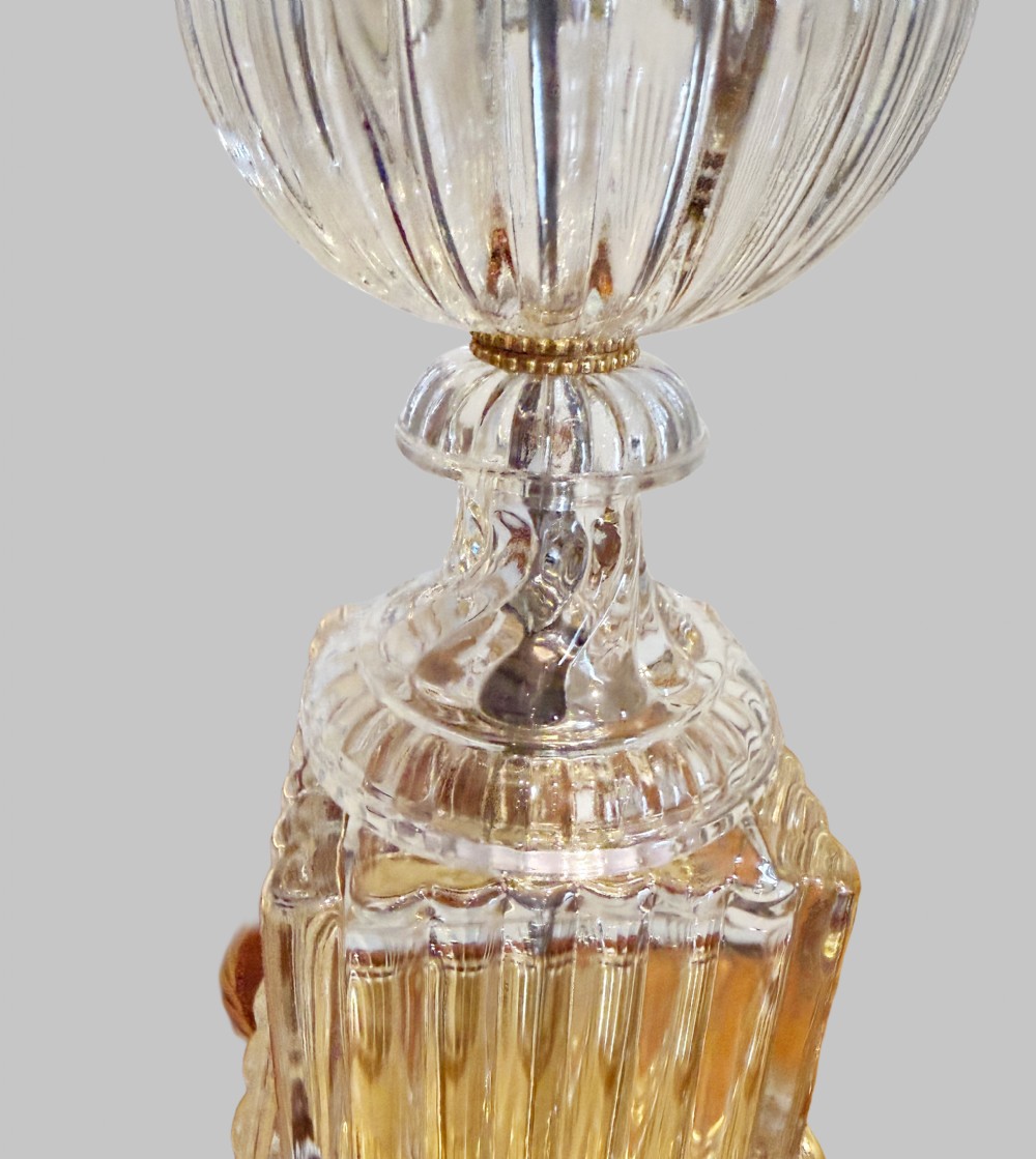 A pair of 19th-century French clear cut-crystal urn-form table lamps featuring spiral fluting, square pedestals, and gilt-metal claw feet. View VII