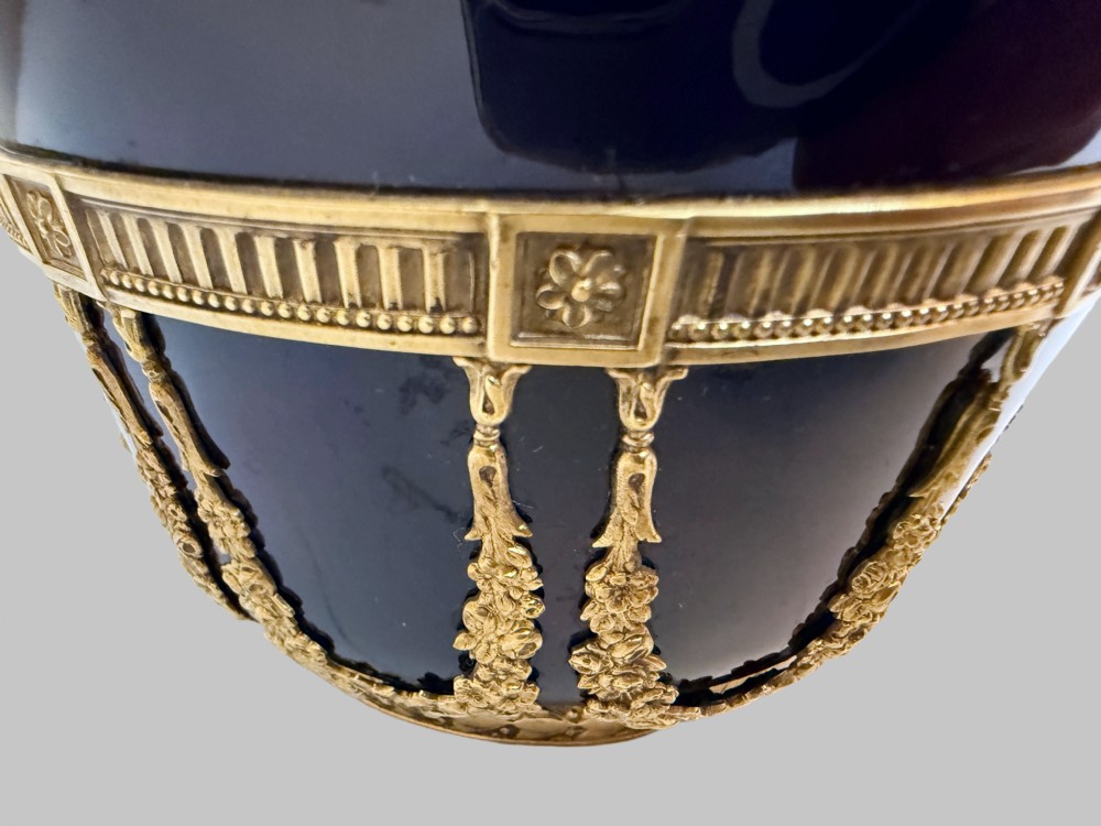 A pair of cobalt blue glass vases featuring ornate gilt bronze floral garlands, ribbon details, and metal rim mounts. View IV
