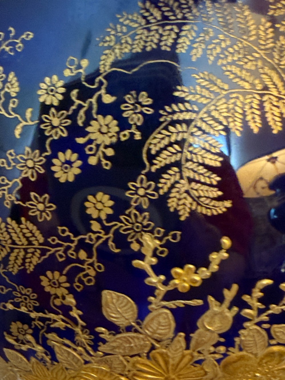 An antique Royal Doulton porcelain vase featuring cobalt blue and white glazes, heavy gilt scrolling, scroll handles with mask terminals, and a central hand-painted floral panel. View IX
