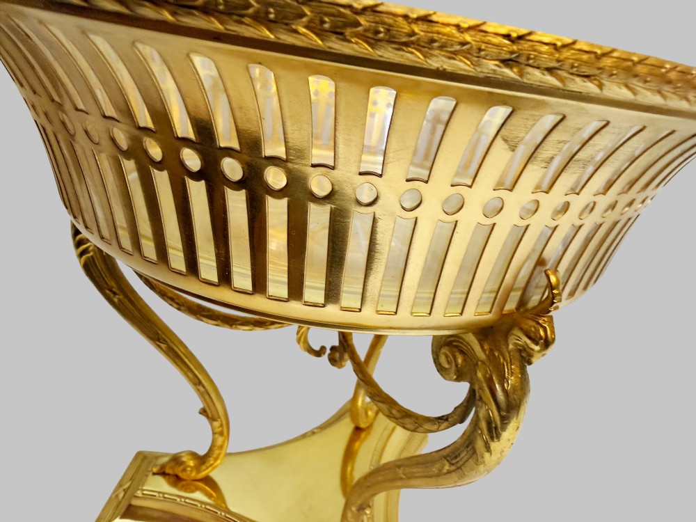 An antique French gilt bronze centrepiece with a pierced metal rim, tri-form base, and scalloped cut glass insert. View IV
