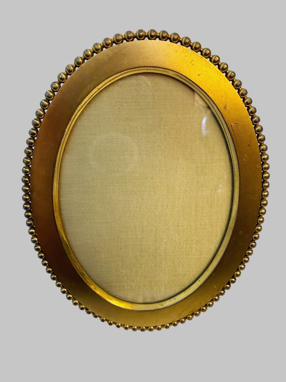 A trio of antique French gilt bronze picture frames featuring ribbon crests, beaded borders, and an onyx panel mount. View III