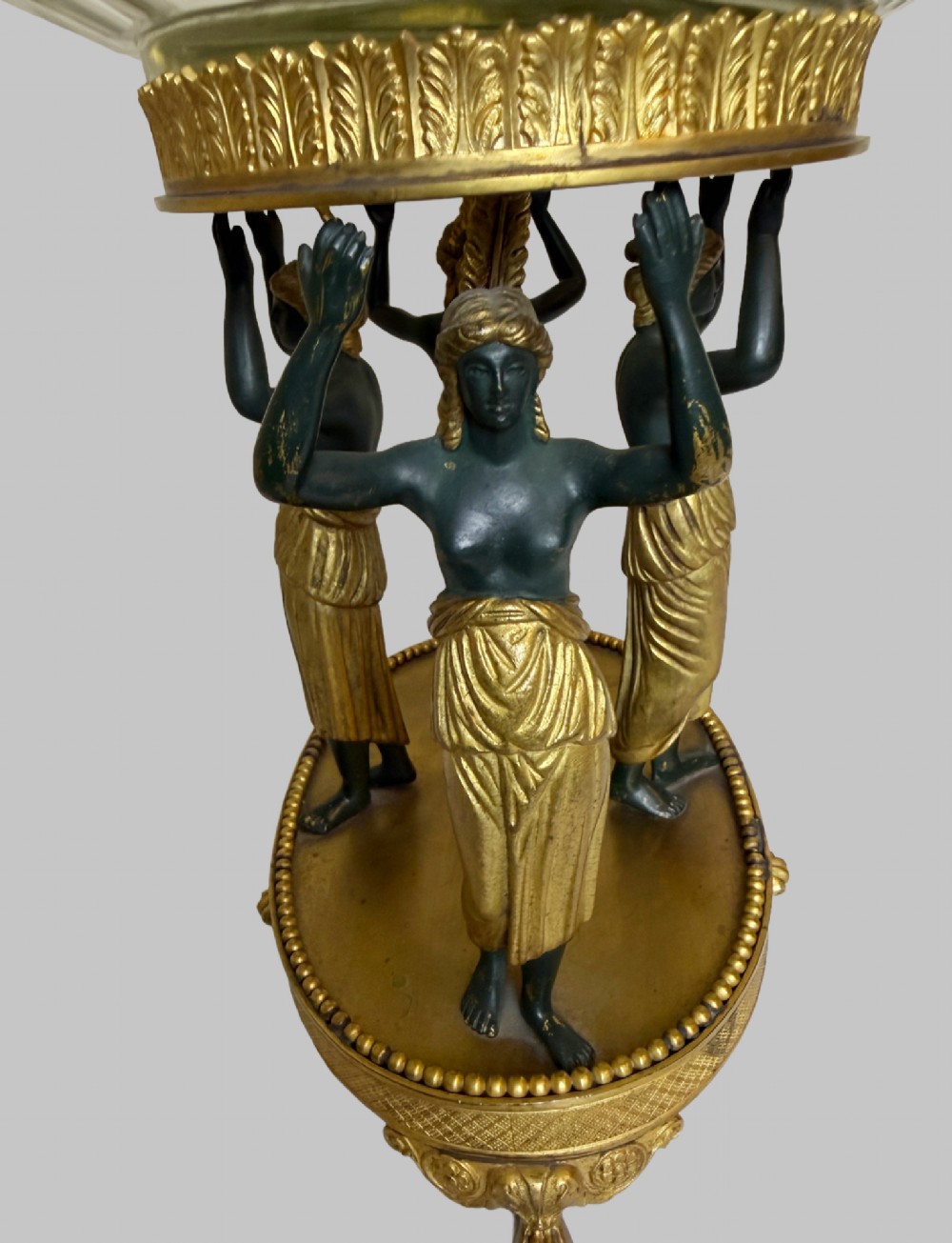 An early 19th-century cut-crystal bowl supported by four patinated bronze female caryatids with gilt drapery, set upon a circular gilt bronze base. View IV
