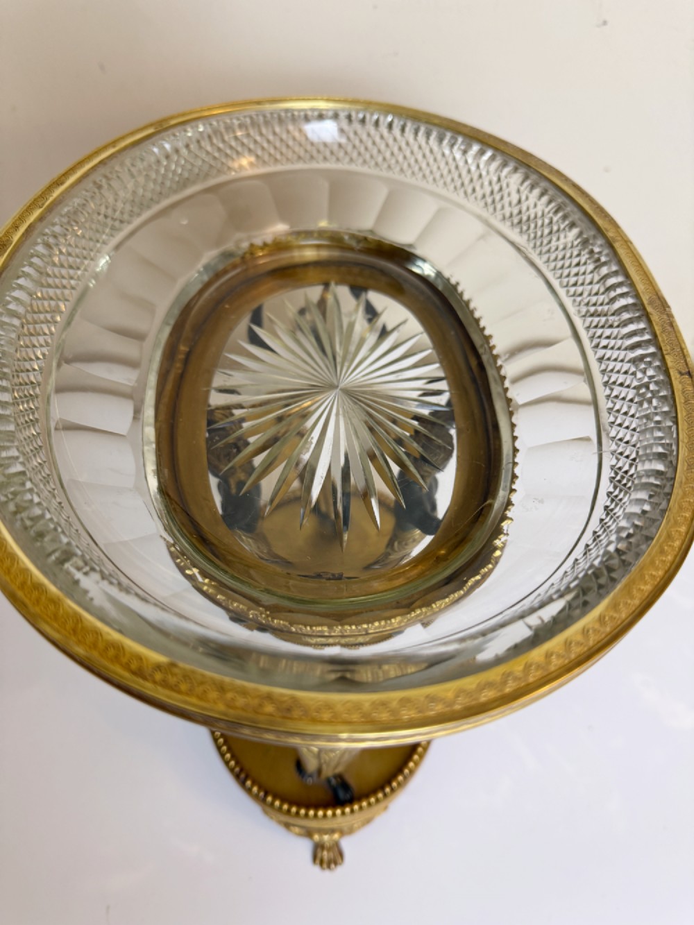 An early 19th-century cut-crystal bowl supported by four patinated bronze female caryatids with gilt drapery, set upon a circular gilt bronze base. View V