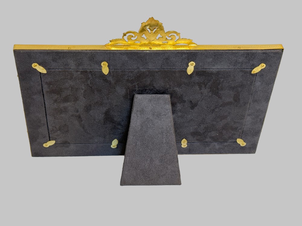 A 19th-century rectangular French gilt bronze frame featuring two circular photograph openings set against a cream silk background, adorned with a floral crest and ribbon mounts. View VII