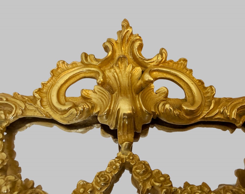 An ornate gold gilt bronze table mirror featuring Rococo scrollwork, floral garlands, and a carved crest motif. View III