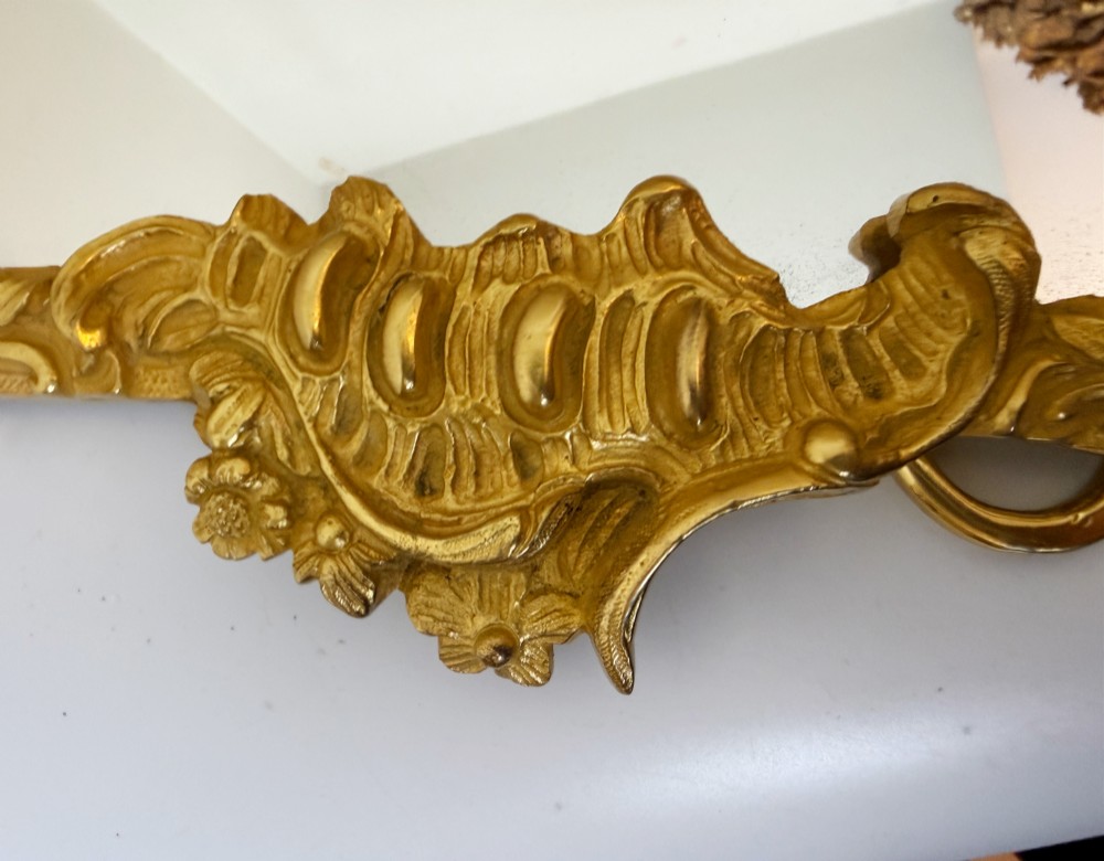 An ornate gold gilt bronze table mirror featuring Rococo scrollwork, floral garlands, and a carved crest motif. View V