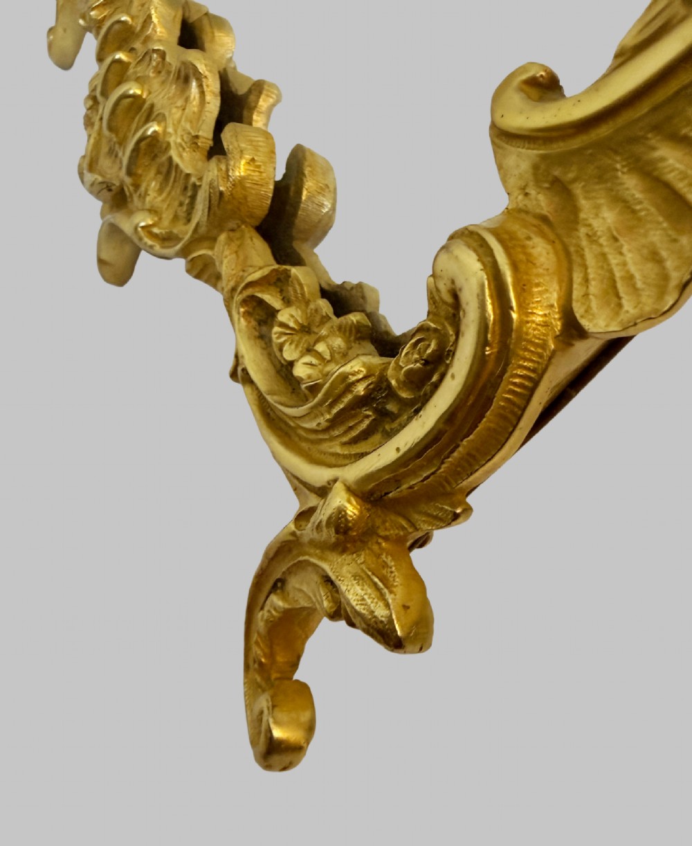 An ornate gold gilt bronze table mirror featuring Rococo scrollwork, floral garlands, and a carved crest motif. View VI