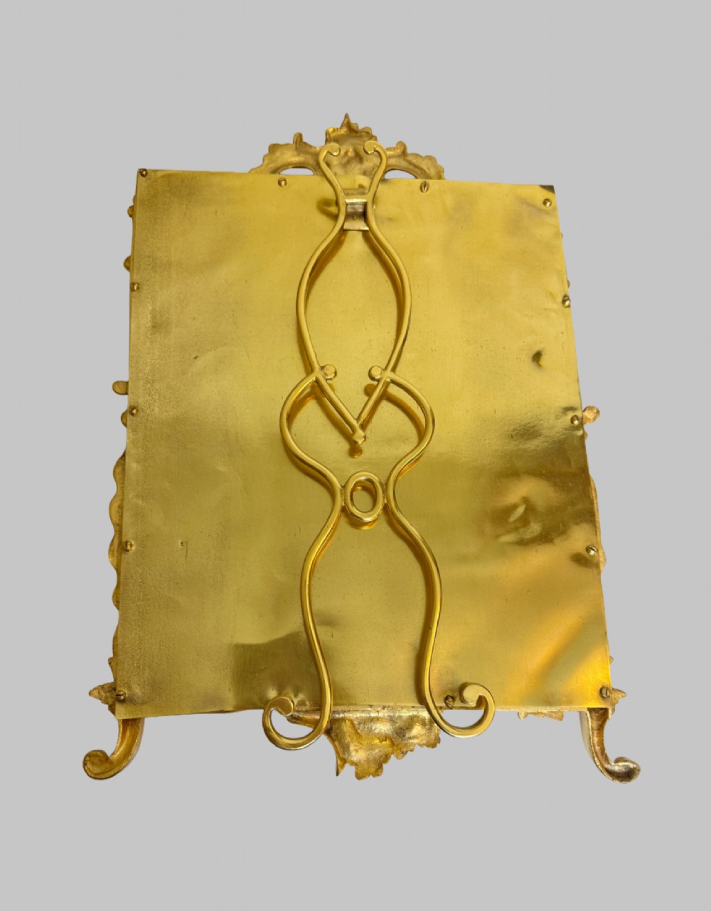 An ornate gold gilt bronze table mirror featuring Rococo scrollwork, floral garlands, and a carved crest motif. View VIII