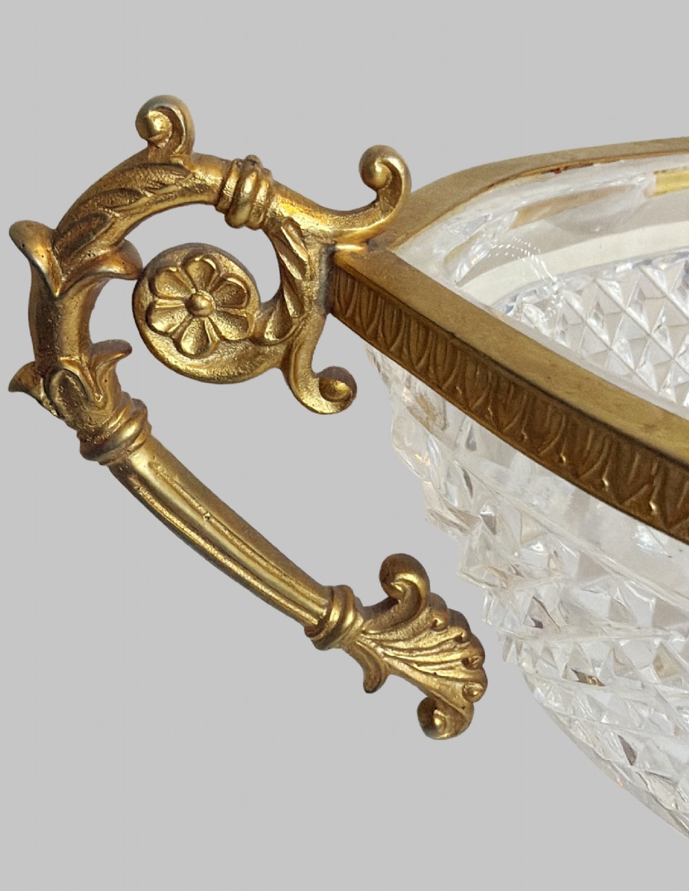 A late 19th-century French boat-shaped cut crystal centrepiece bowl set within gilded bronze mounts with dual scroll handles and a footed square base. View III