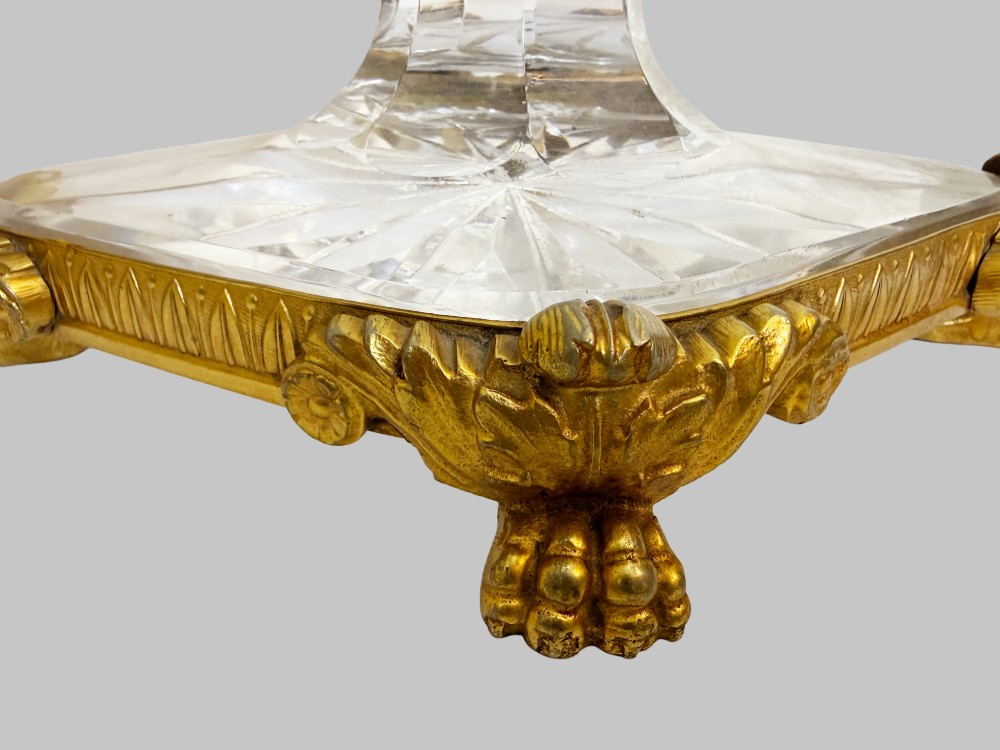 A late 19th-century French boat-shaped cut crystal centrepiece bowl set within gilded bronze mounts with dual scroll handles and a footed square base. View V