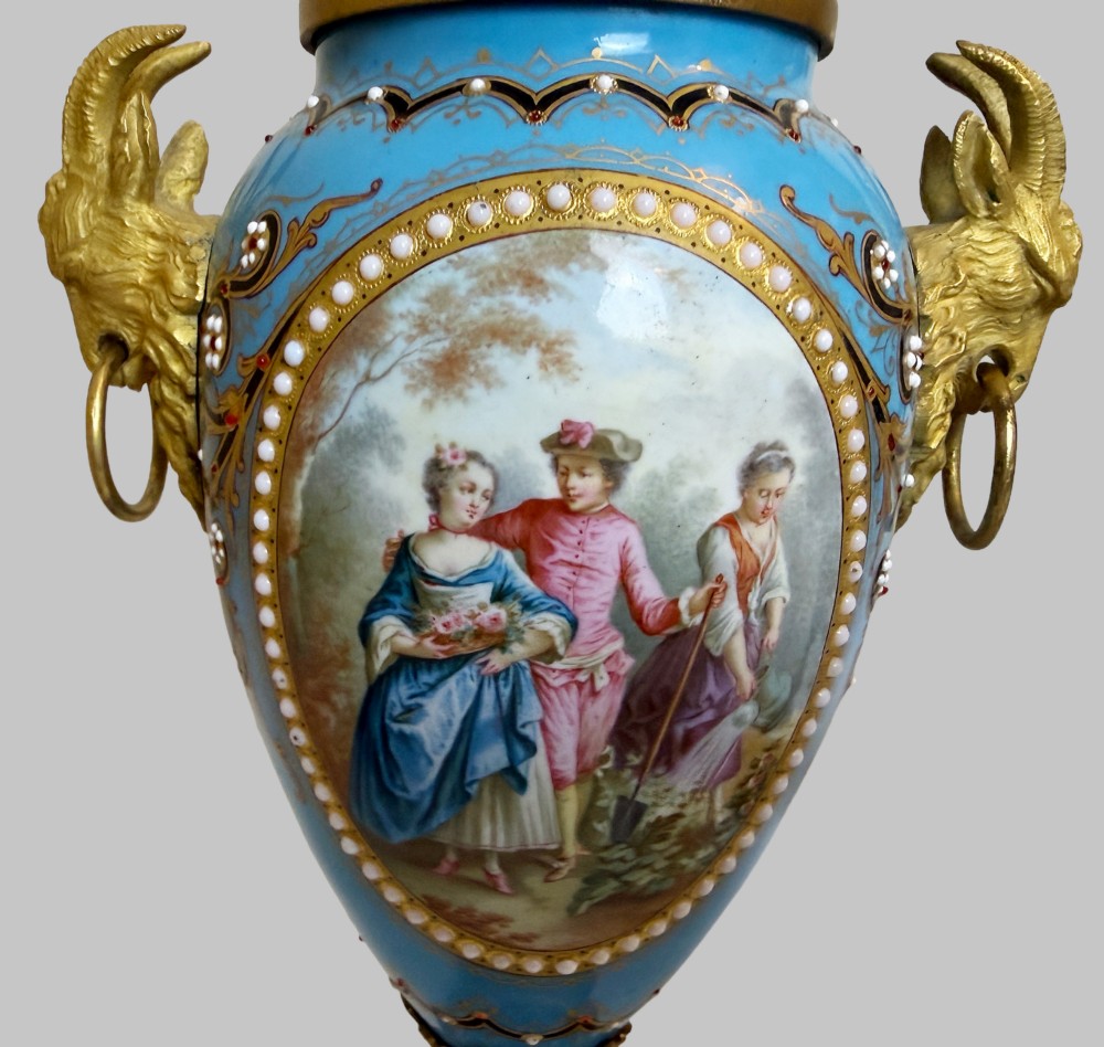 A pair of turquoise blue enamelled cassolette urns featuring gilt-bronze ram head handles, flame finials, and painted romantic pastoral vignettes. View III
