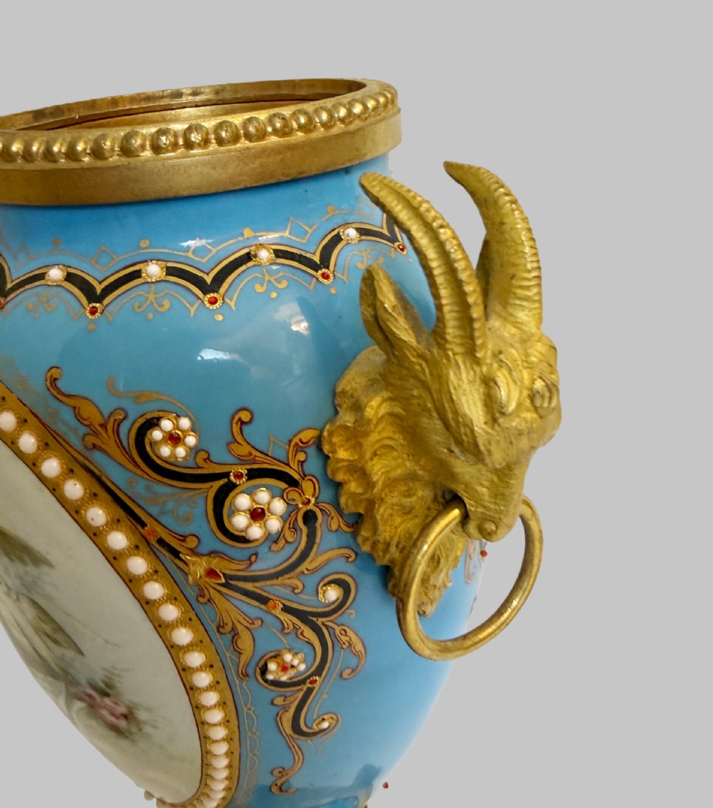 A pair of turquoise blue enamelled cassolette urns featuring gilt-bronze ram head handles, flame finials, and painted romantic pastoral vignettes. View VII