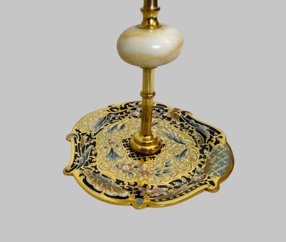 A pair of 19th-century gilt bronze candlesticks featuring floral champleve enamel decoration, central onyx knops, and shaped wide bases. View II