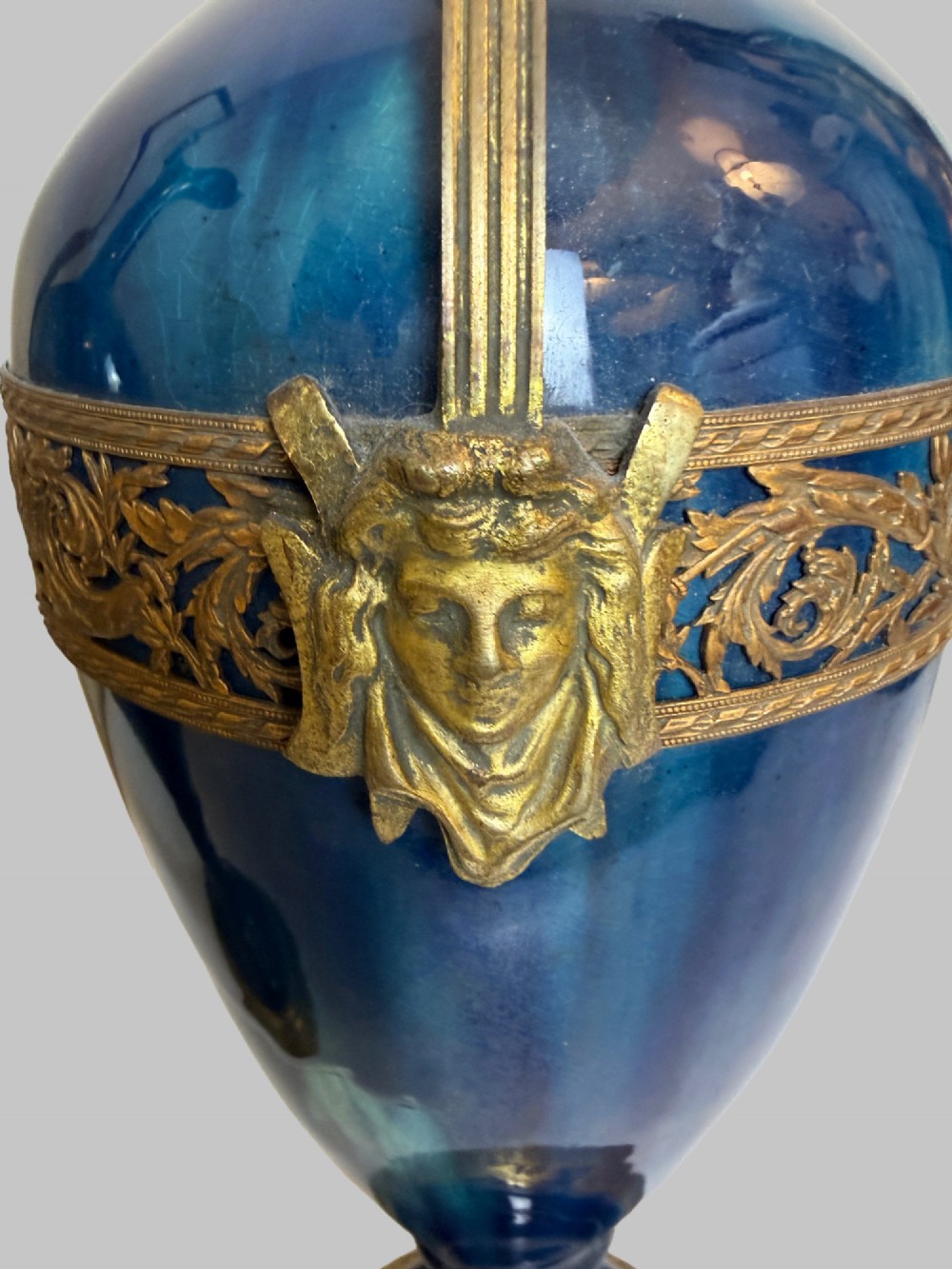 A pair of slender blue porcelain ewers featuring decorative gilt bronze mounts, angular handles, and flared spouts. View VIII