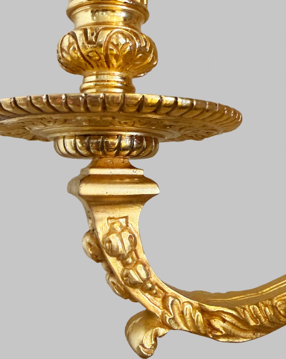 A pair of late nineteenth-century French gilt bronze five-light wall sconces featuring ornate rococo scrollwork and mascaron motifs. View V