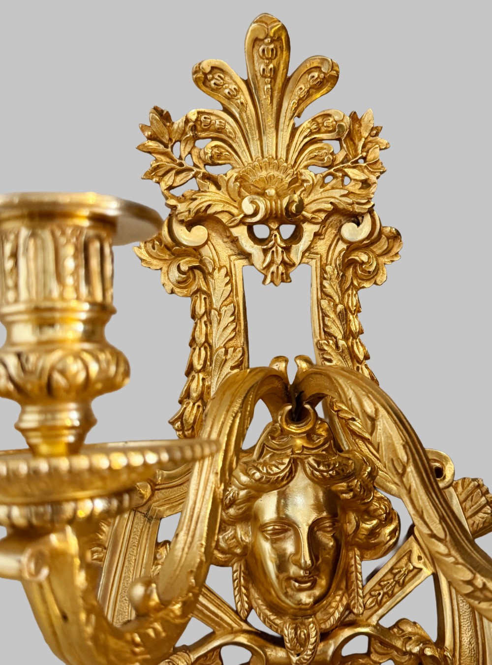A pair of late nineteenth-century French gilt bronze five-light wall sconces featuring ornate rococo scrollwork and mascaron motifs. View VI