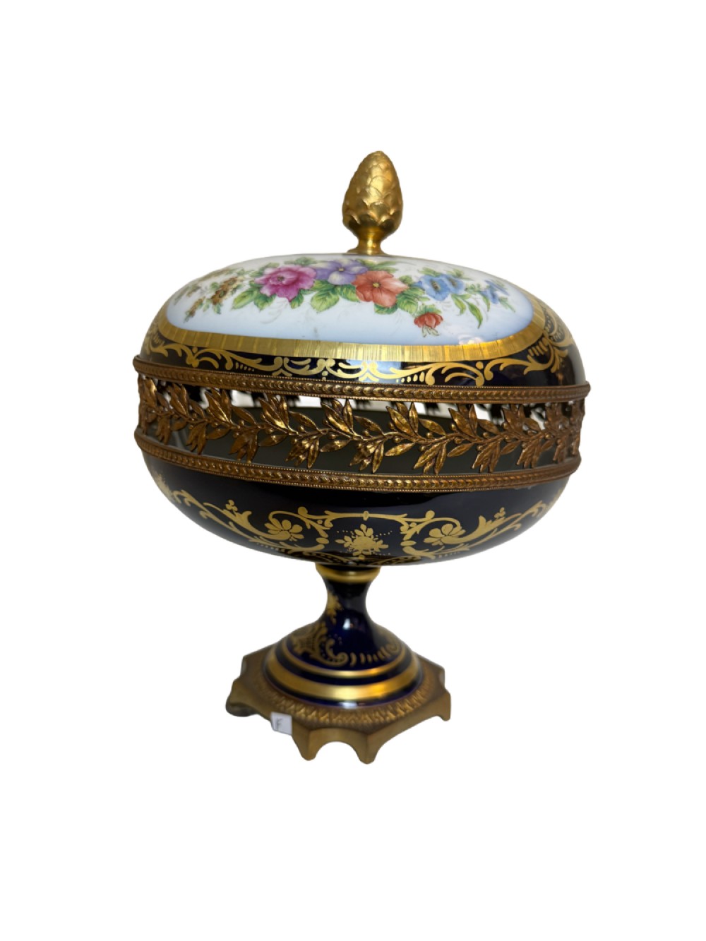 A late 19th-century French cobalt blue Limoges porcelain lidded dish decorated with hand-painted flowers, gilded scrollwork, a pierced brass gallery, and a pinecone finial.