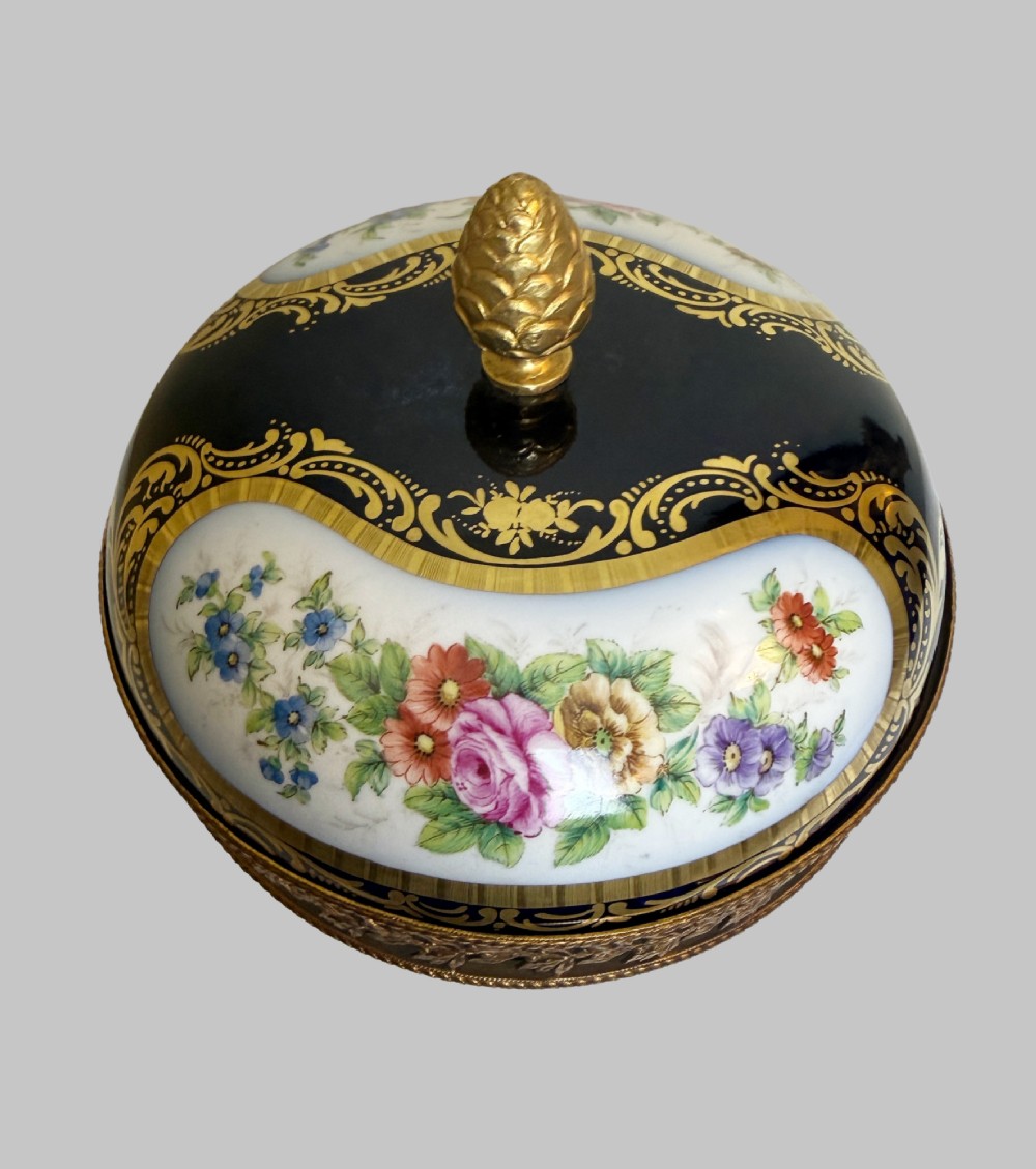 A late 19th-century French cobalt blue Limoges porcelain lidded dish decorated with hand-painted flowers, gilded scrollwork, a pierced brass gallery, and a pinecone finial. View II