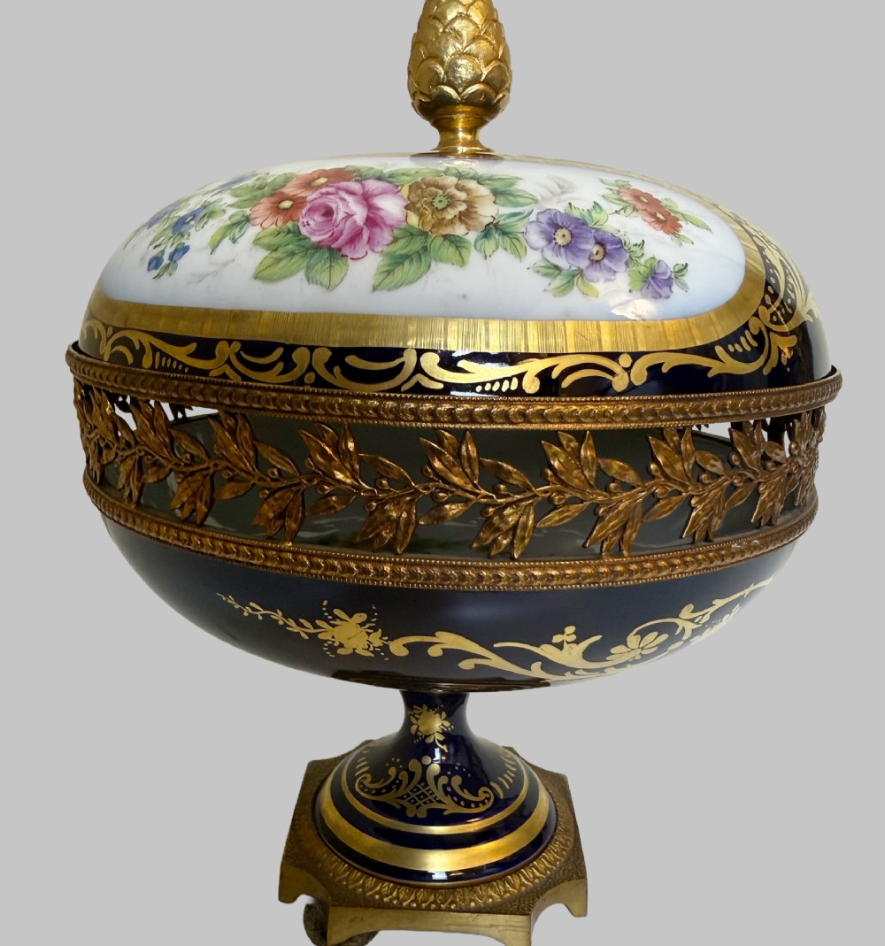 A late 19th-century French cobalt blue Limoges porcelain lidded dish decorated with hand-painted flowers, gilded scrollwork, a pierced brass gallery, and a pinecone finial. View V