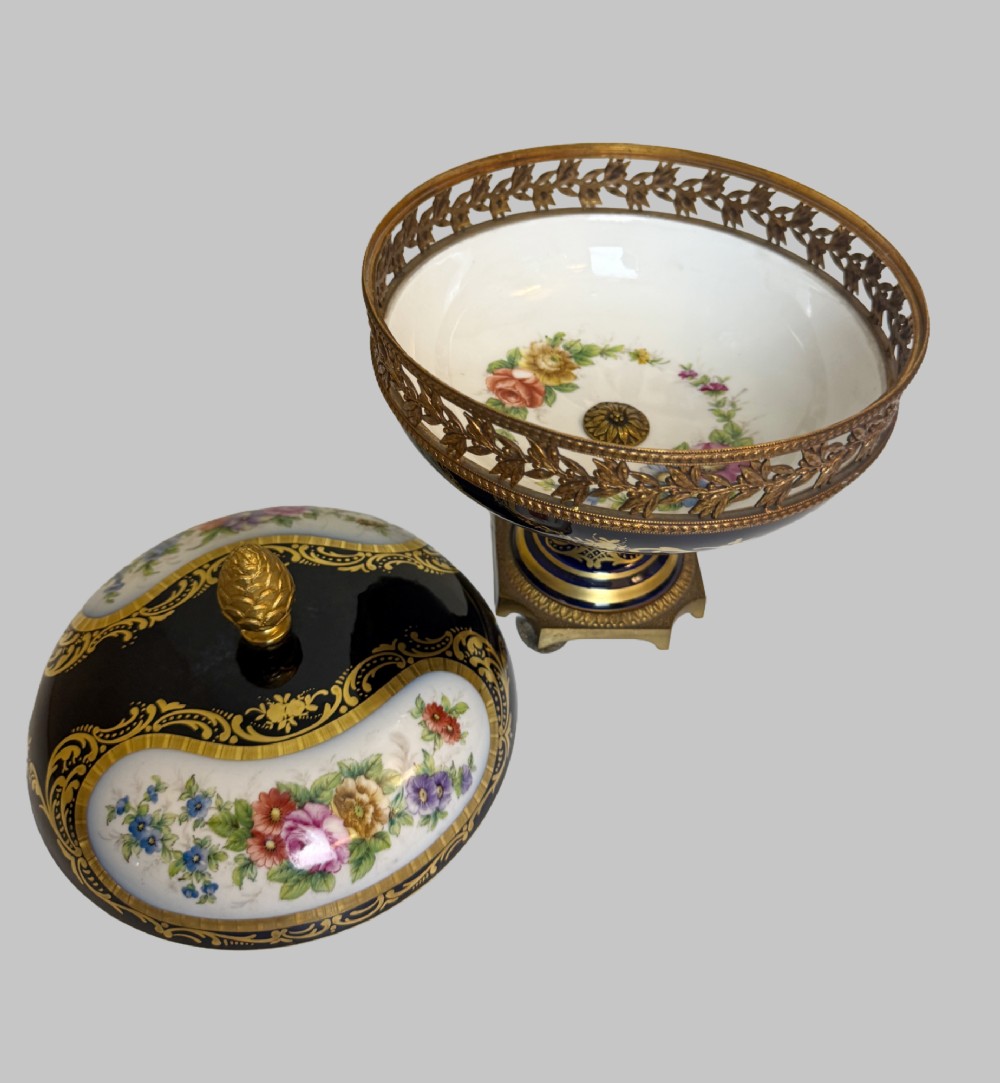 A late 19th-century French cobalt blue Limoges porcelain lidded dish decorated with hand-painted flowers, gilded scrollwork, a pierced brass gallery, and a pinecone finial. View VI