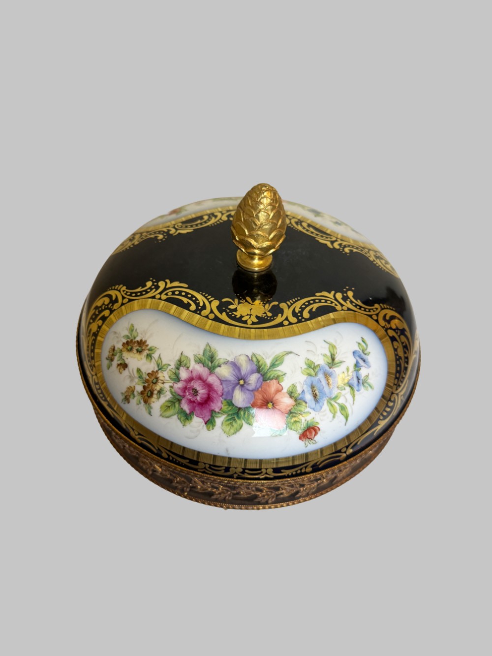A late 19th-century French cobalt blue Limoges porcelain lidded dish decorated with hand-painted flowers, gilded scrollwork, a pierced brass gallery, and a pinecone finial. View VII