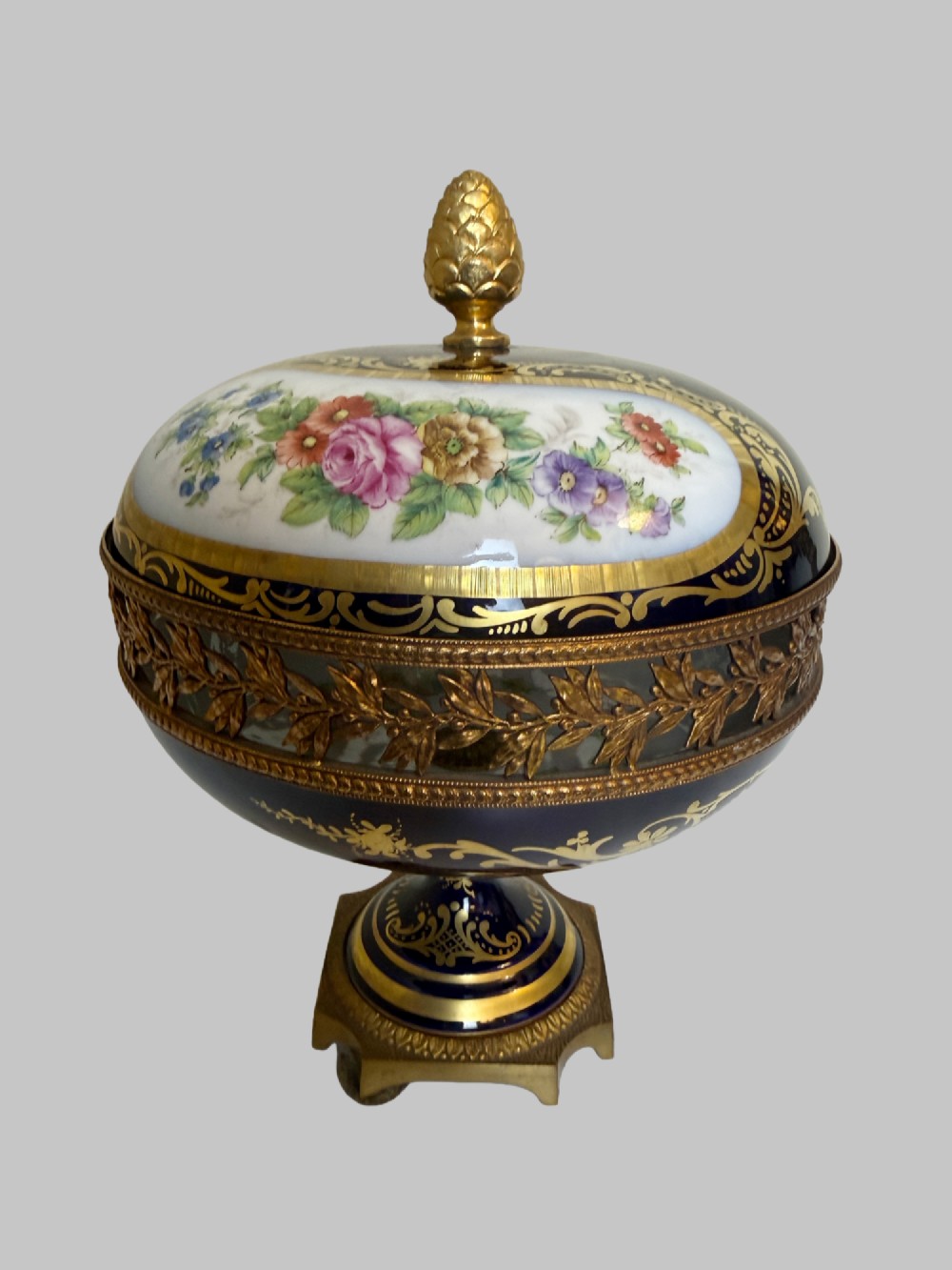A late 19th-century French cobalt blue Limoges porcelain lidded dish decorated with hand-painted flowers, gilded scrollwork, a pierced brass gallery, and a pinecone finial. View VIII