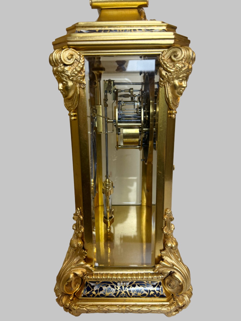 A late 19th-century French clock garniture featuring a gilt bronze mantel clock flanked by two matching champleve enamel side urns. View VII