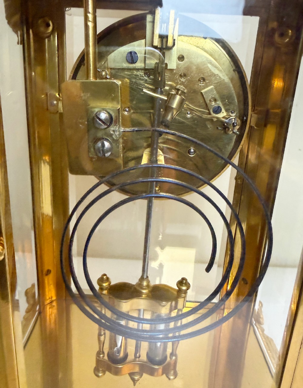 A late 19th-century French clock garniture featuring a gilt bronze mantel clock flanked by two matching champleve enamel side urns. View IX