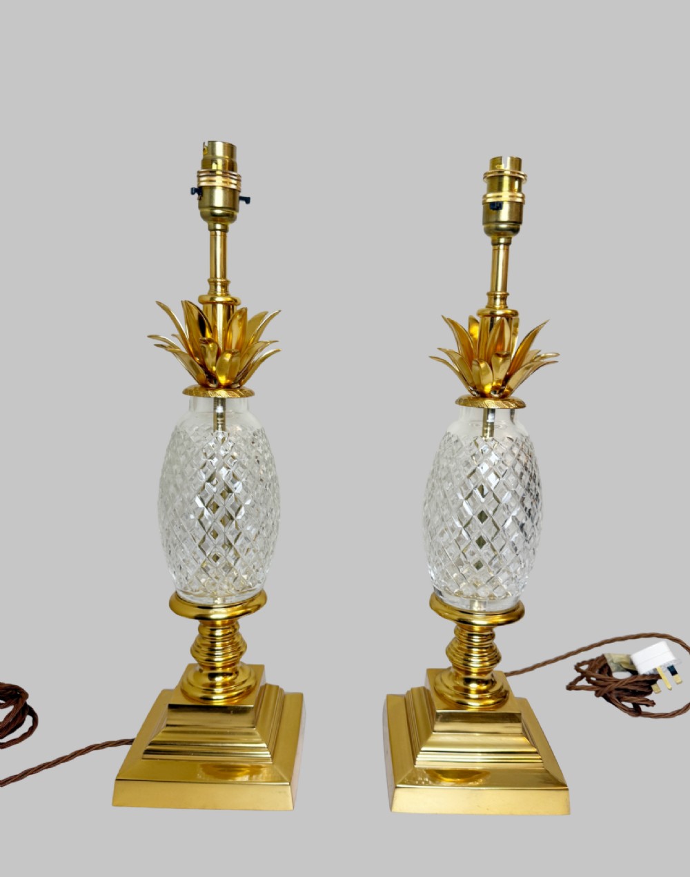 A pair of French gilt bronze and cut crystal table lamps designed in the shape of pineapples on square stepped bases. View II