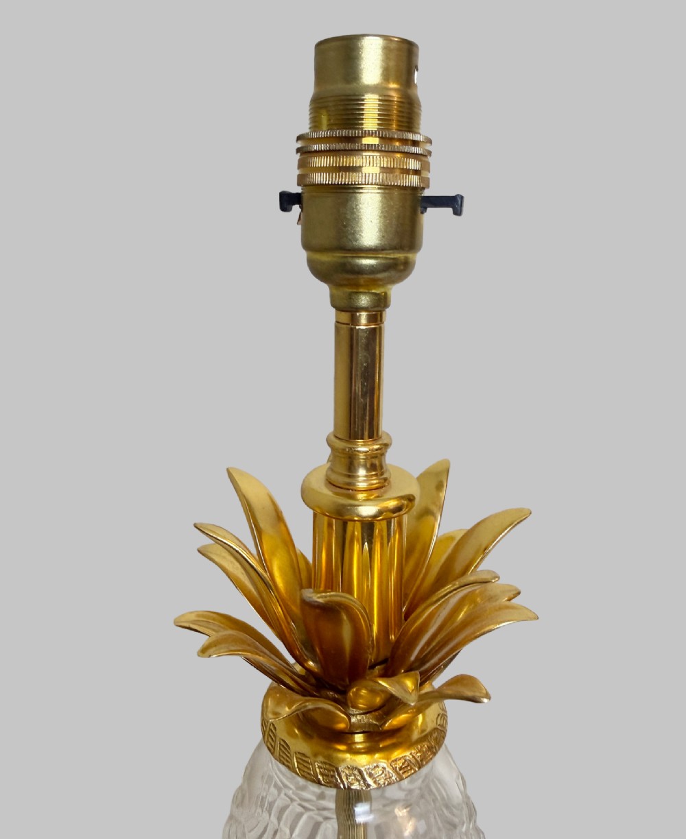A pair of French gilt bronze and cut crystal table lamps designed in the shape of pineapples on square stepped bases. View V