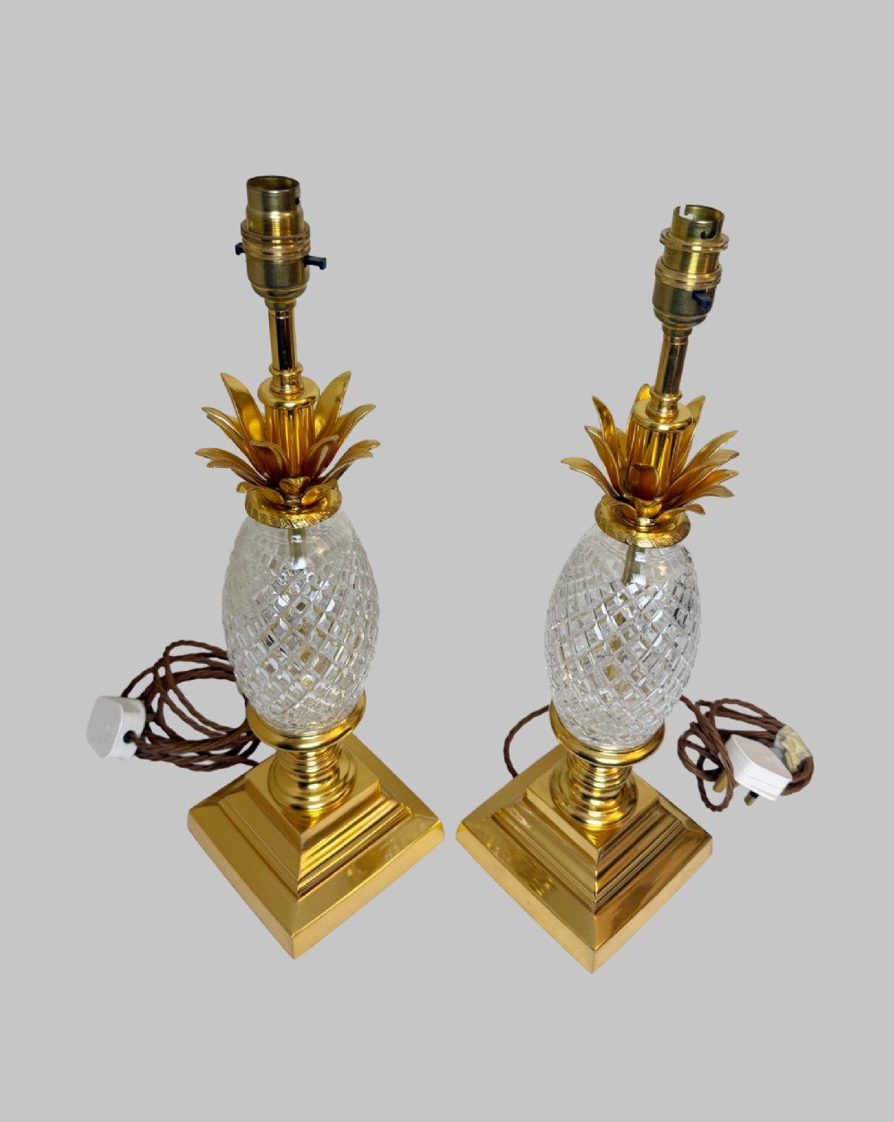 A pair of French gilt bronze and cut crystal table lamps designed in the shape of pineapples on square stepped bases. View VI