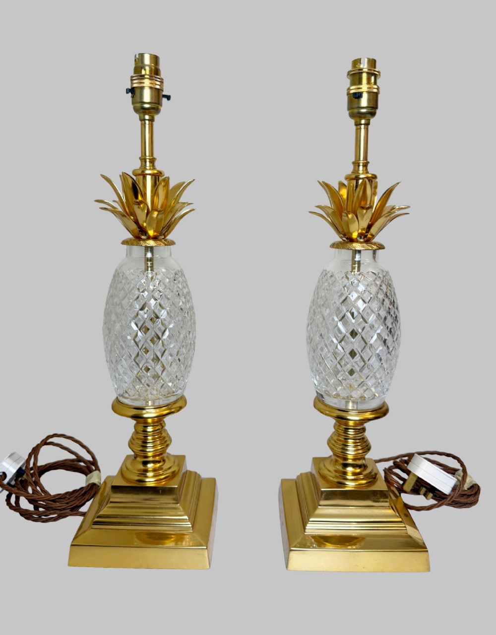 A pair of French gilt bronze and cut crystal table lamps designed in the shape of pineapples on square stepped bases. View VII