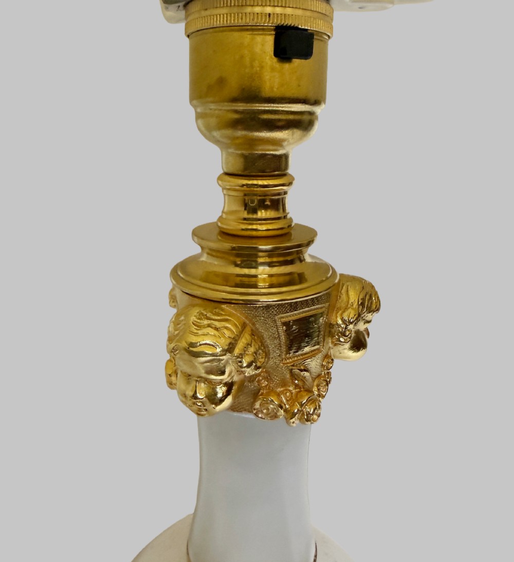 A pair of French onyx urn-shaped table lamps featuring gilt bronze dolphin feet and cream pleated shades. View VI