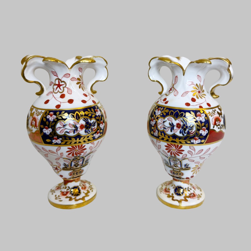 A pair of 19th-century Spode porcelain twin-handled vases decorated in a cobalt blue, iron red, and gold leaf Imari pattern. View II