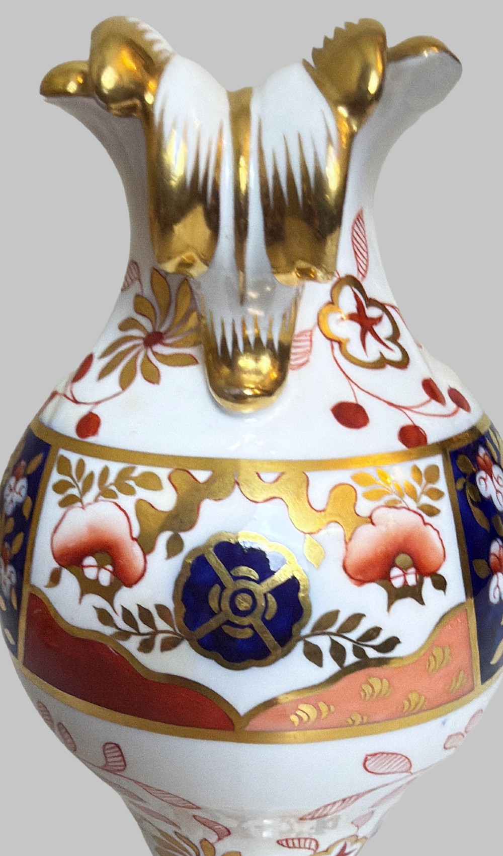 A pair of 19th-century Spode porcelain twin-handled vases decorated in a cobalt blue, iron red, and gold leaf Imari pattern. View IV