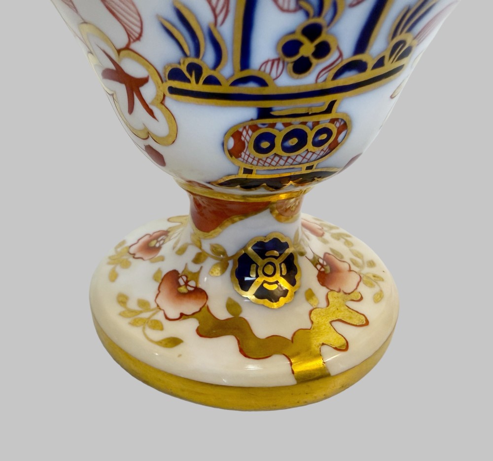 A pair of 19th-century Spode porcelain twin-handled vases decorated in a cobalt blue, iron red, and gold leaf Imari pattern. View V
