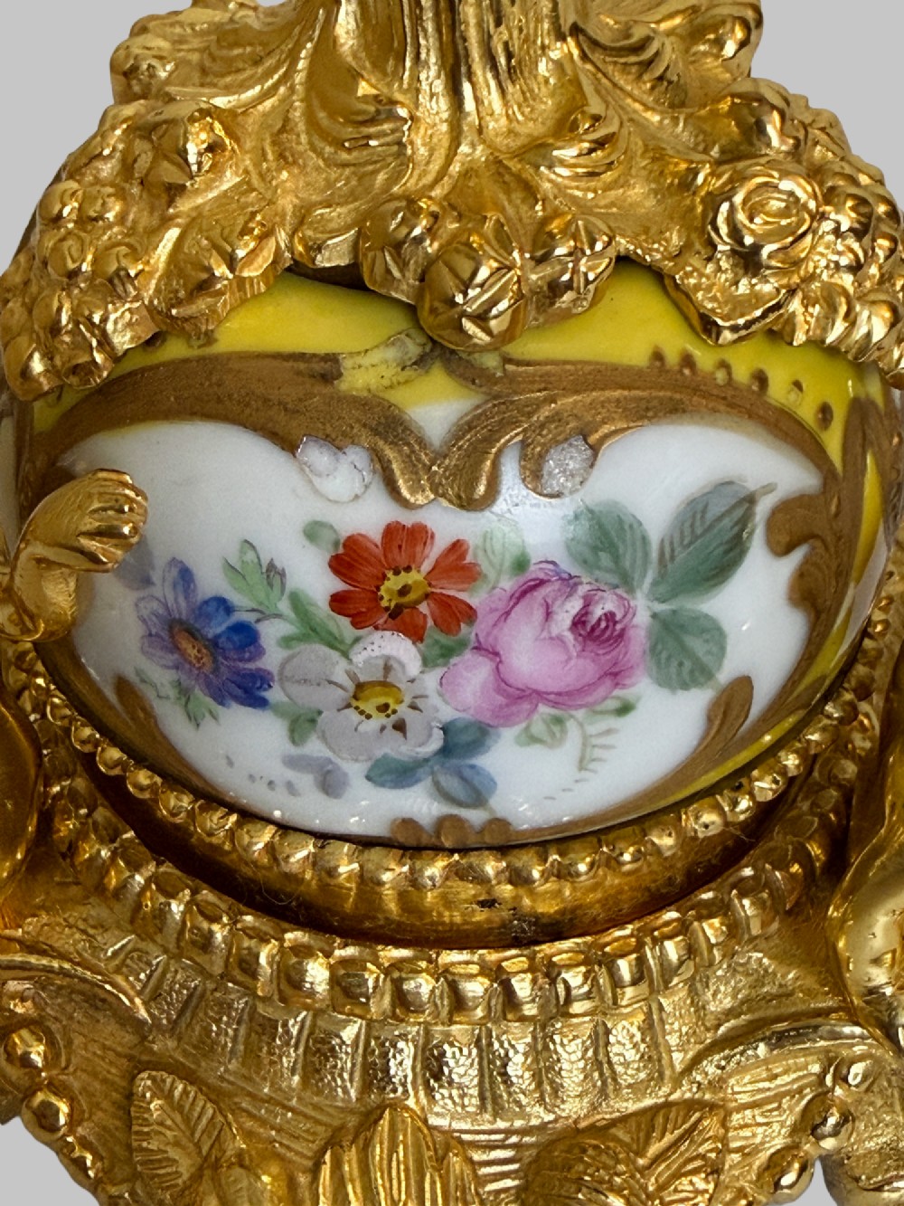 An ornate gilt bronze centrepiece dish featuring a cut crystal bowl, hand-painted porcelain cherub panels, and three seated bronze putti figures on a scrolled base. View II