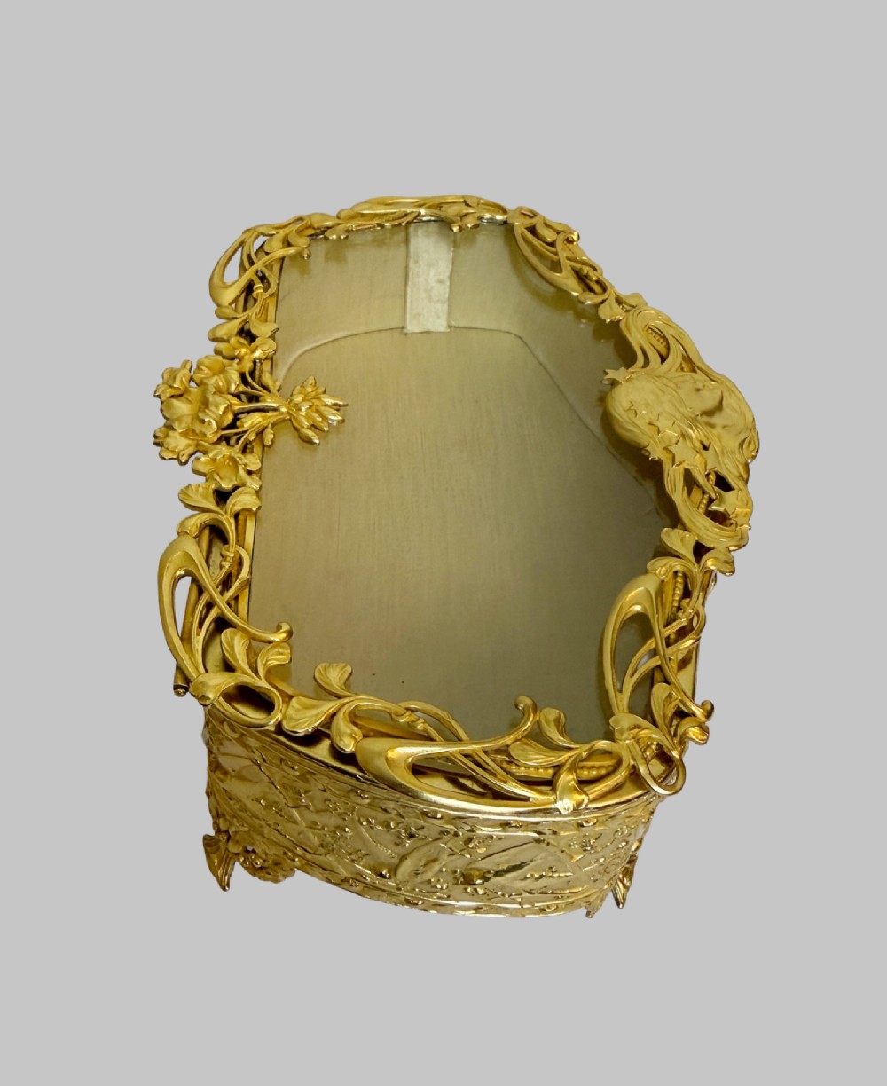 An Art Nouveau gilt bronze jewellery box featuring embossed bird motifs and a bevelled glass lid. View IV