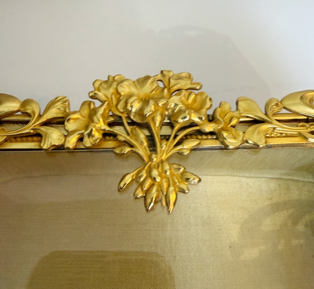 An Art Nouveau gilt bronze jewellery box featuring embossed bird motifs and a bevelled glass lid. View VII