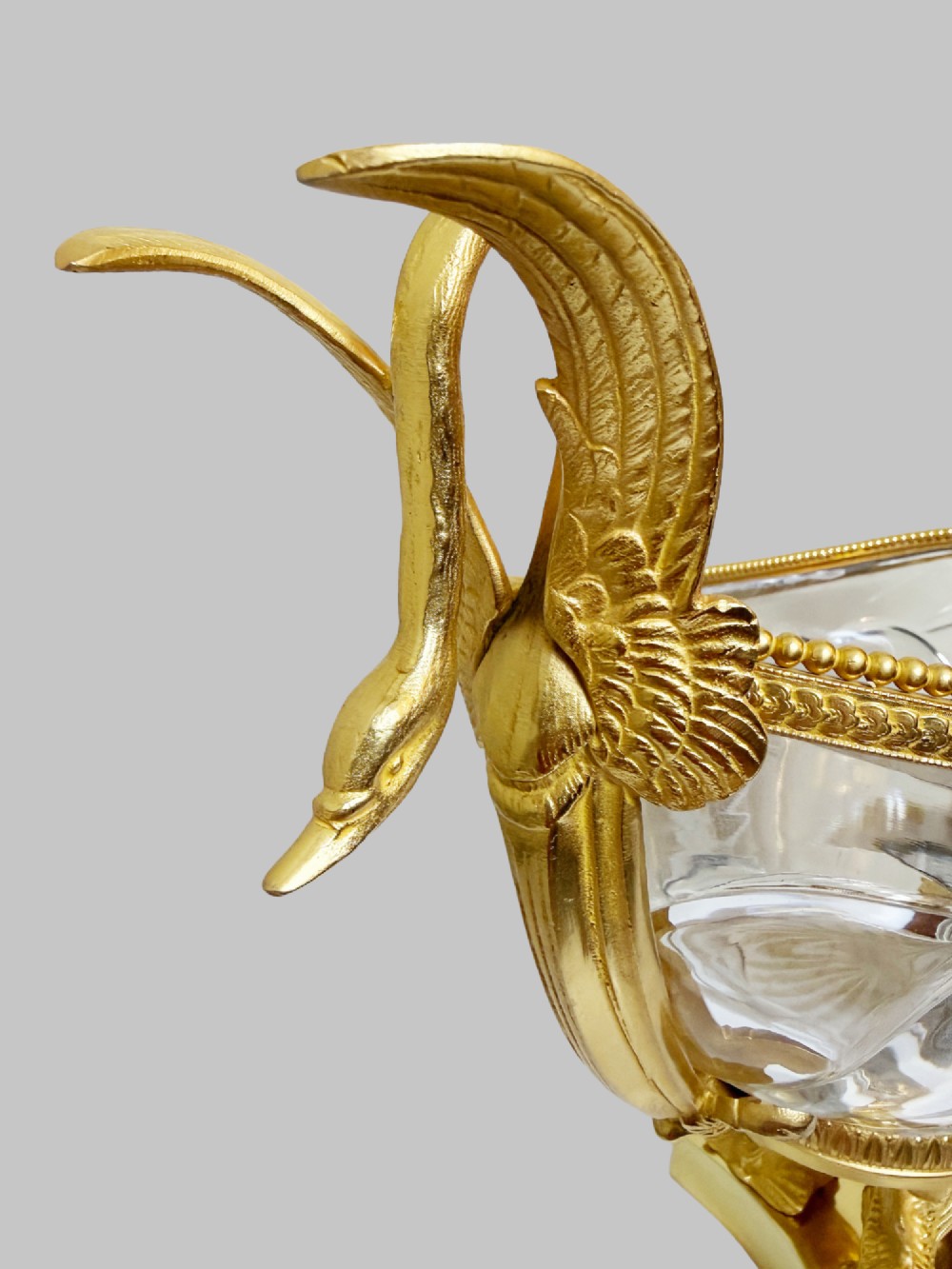 A 19th-century boat-shaped cut-crystal bowl with gilt-bronze swan-form handles and a pedestal base supported by gilt dolphins. View IV