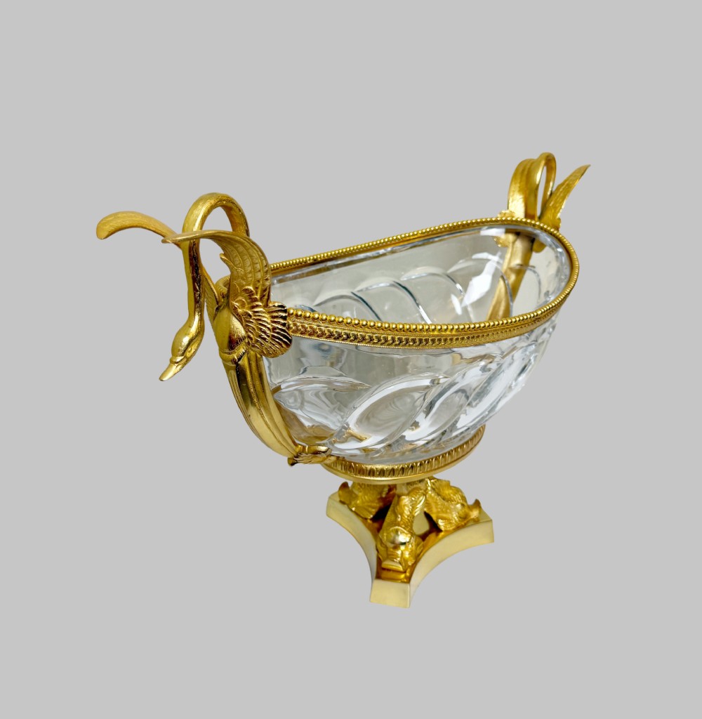A 19th-century boat-shaped cut-crystal bowl with gilt-bronze swan-form handles and a pedestal base supported by gilt dolphins. View V